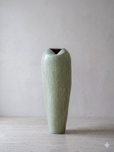 Minimalist pastel green tadelakt ceramic vase with an organic asymmetrical opening